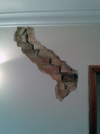 Crack in wall repaired with plaster